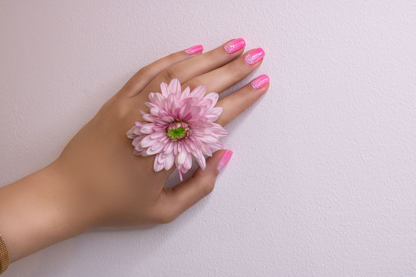Soft pink polished nails with a flower